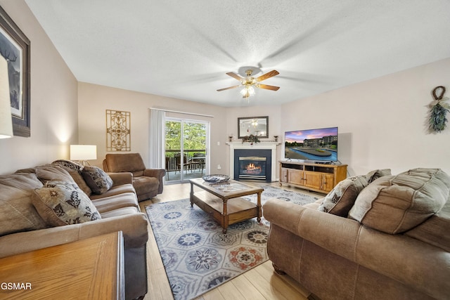 205 Ogle Dr Unit 614, Pigeon Forge, TN 37863 - living area with light wood-style flooring, a ceiling fan, and a glass covered fireplace