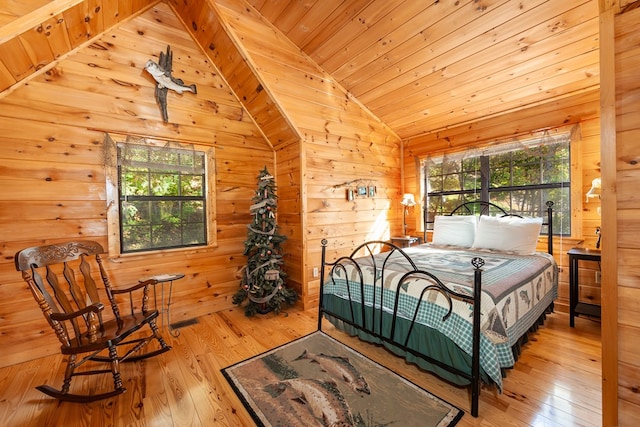 bedroom featuring vaulted ceiling, hardwood / wood-style floors, wood walls, and wooden ceiling