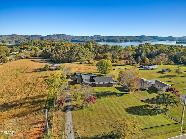 drone / aerial view with a water and mountain view and a rural view