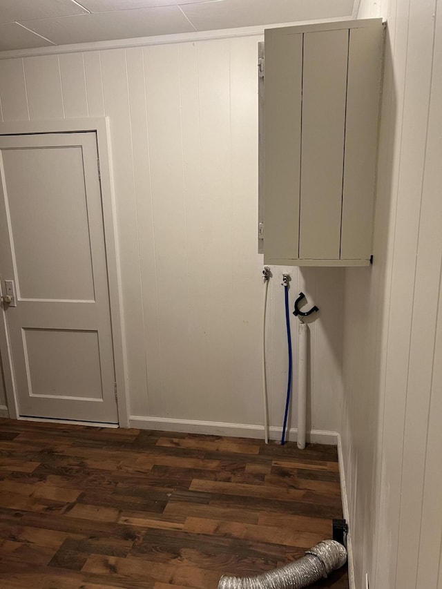 clothes washing area featuring cabinets and dark hardwood / wood-style floors