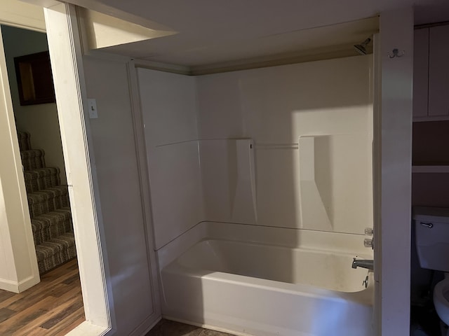 bathroom featuring shower / bathing tub combination and hardwood / wood-style flooring