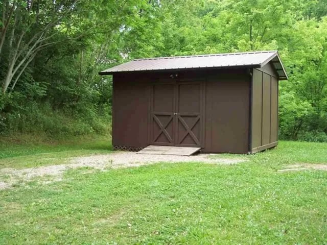 view of outdoor structure featuring a lawn