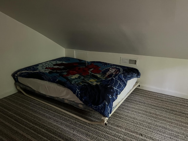 carpeted bedroom with vaulted ceiling