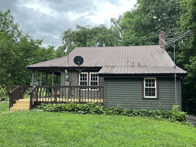 view of front of property with a front lawn and a wooden deck