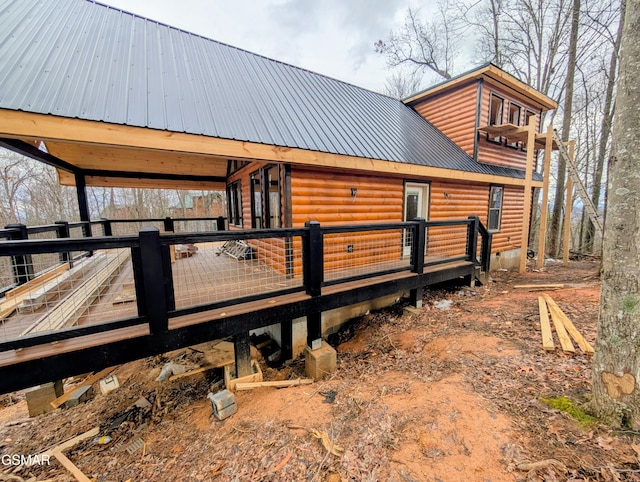 view of property exterior featuring a wooden deck