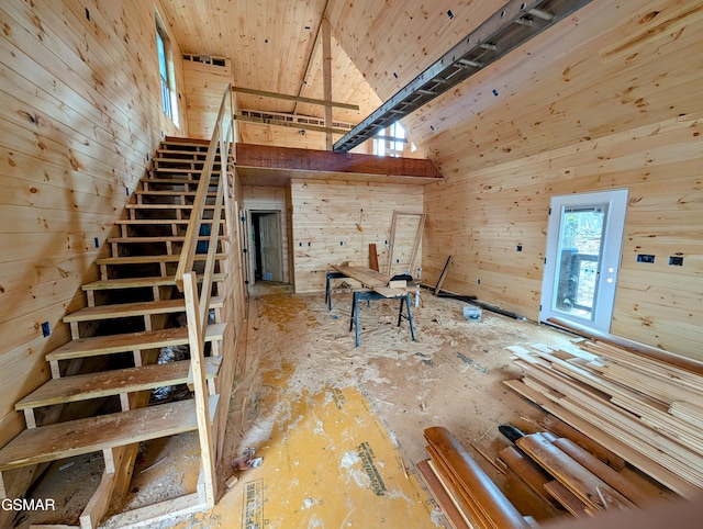 interior space featuring wooden walls and high vaulted ceiling