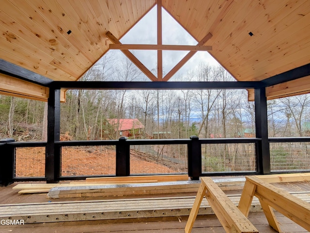 unfurnished sunroom featuring vaulted ceiling and wood ceiling