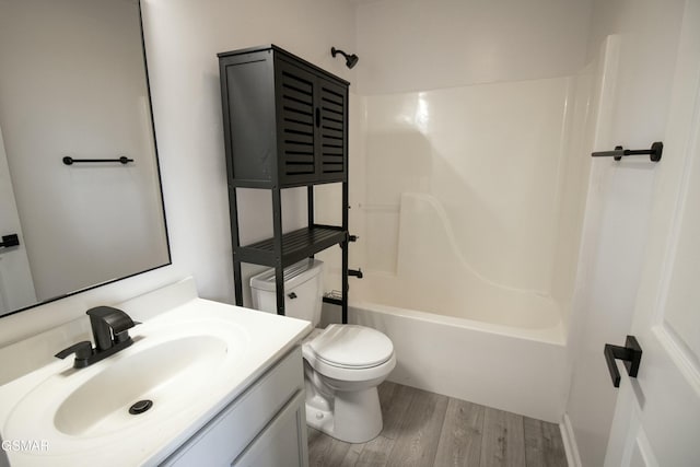 full bathroom with toilet, shower / bathing tub combination, vanity, and wood finished floors