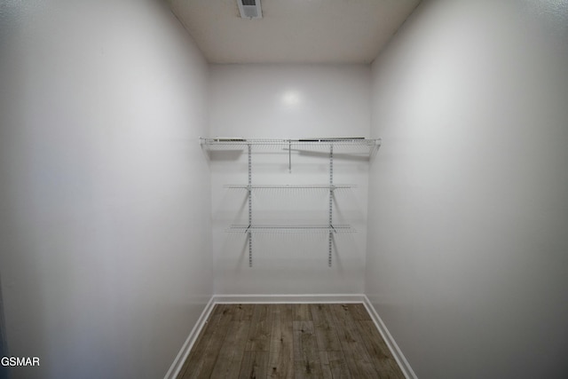 spacious closet featuring visible vents and wood finished floors