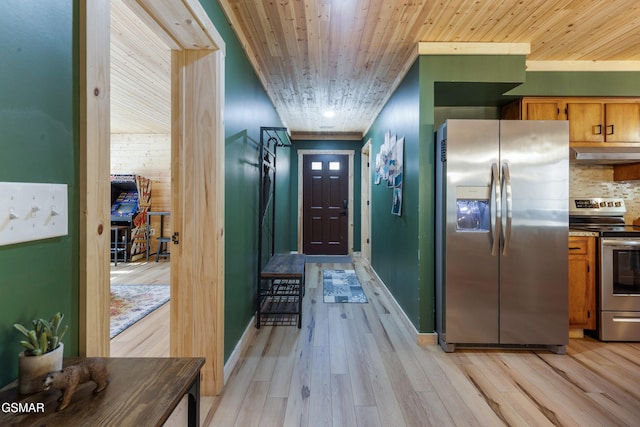 4323 Boogertown Rd, Sevierville, TN 37876 - kitchen featuring brown cabinetry, under cabinet range hood, light wood-style flooring, backsplash, and appliances with stainless steel finishes