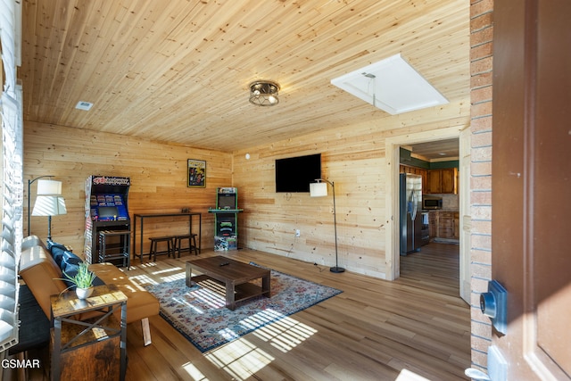 4323 Boogertown Rd, Sevierville, TN 37876 - living area featuring wooden walls, a skylight, wooden ceiling, and wood finished floors