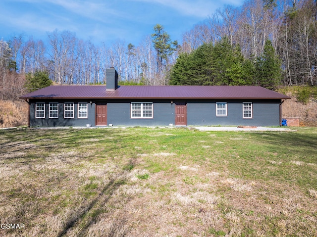 4323 Boogertown Rd, Sevierville, TN 37876 - back of house featuring a yard, brick siding, metal roof, and a chimney