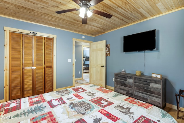 4323 Boogertown Rd, Sevierville, TN 37876 - bedroom featuring a closet, crown molding, a ceiling fan, wood ceiling, and baseboards