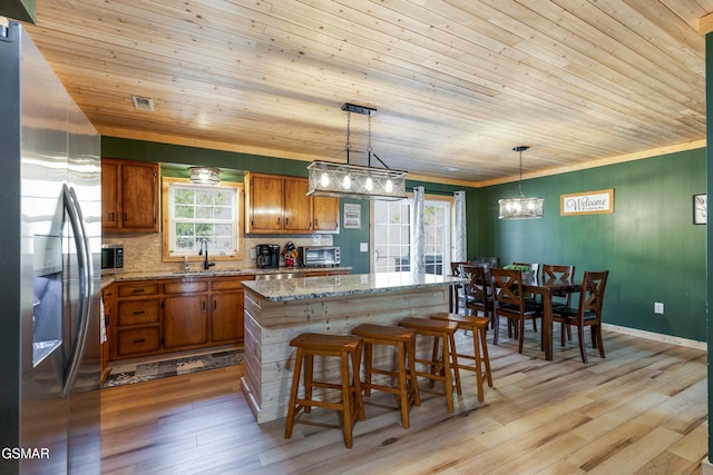 4323 Boogertown Rd, Sevierville, TN 37876 - kitchen with brown cabinets, wood ceiling, stainless steel fridge, and a sink