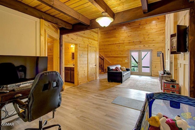 home office with light wood finished floors, wooden walls, wood ceiling, beamed ceiling, and french doors