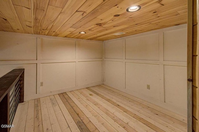 interior space with hardwood / wood-style floors, recessed lighting, and a decorative wall