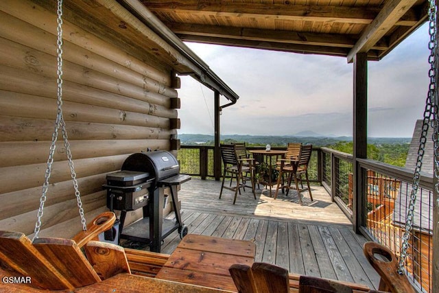 wooden deck with grilling area and a mountain view