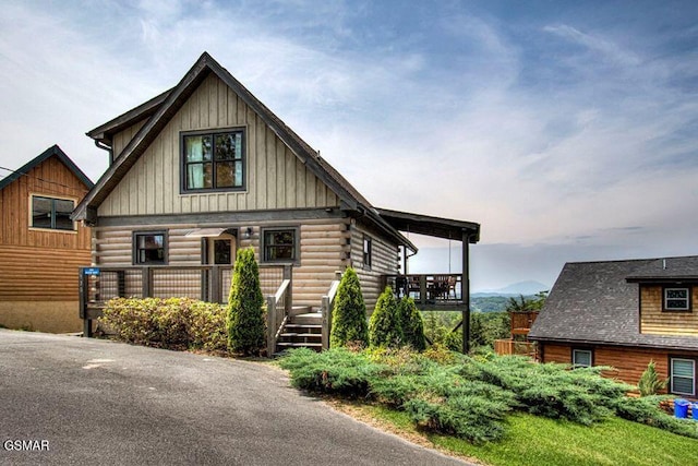 log home with a porch and log siding