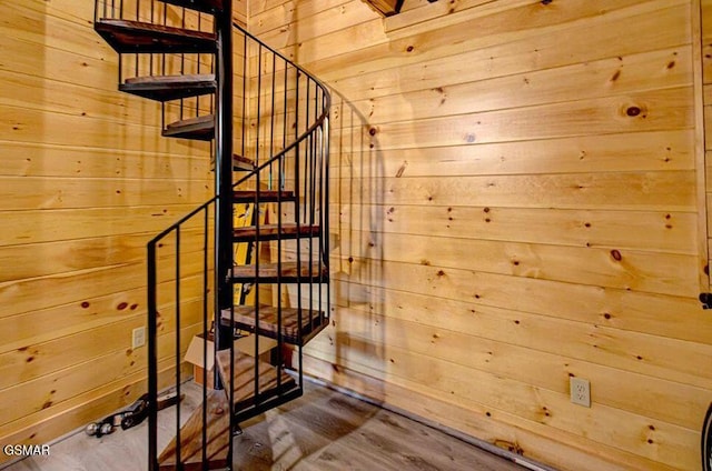 staircase with wood walls