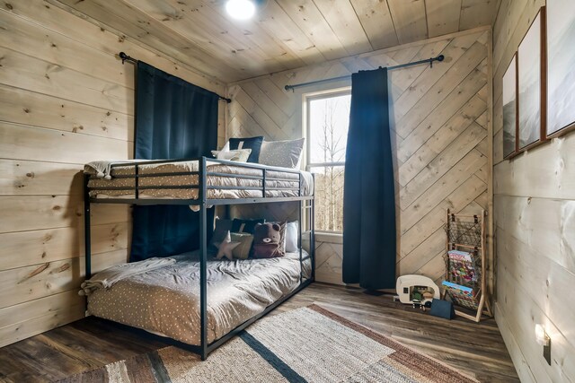 bedroom with wood-type flooring, wooden walls, and wood ceiling