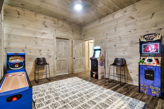 game room featuring wood ceiling, wood walls, and dark hardwood / wood-style floors