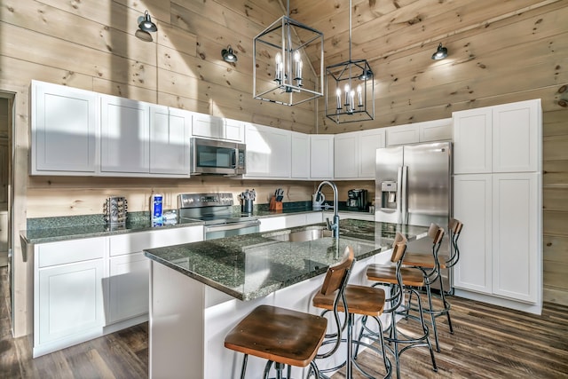 kitchen with sink, a center island with sink, white cabinets, and appliances with stainless steel finishes