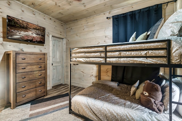 bedroom with wooden ceiling and wooden walls