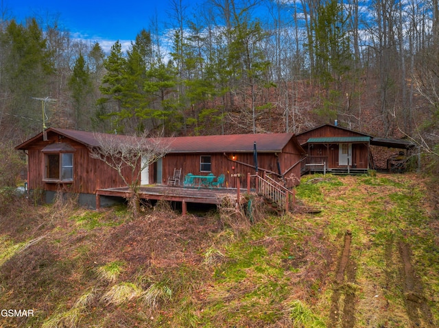 back of property featuring a wooden deck