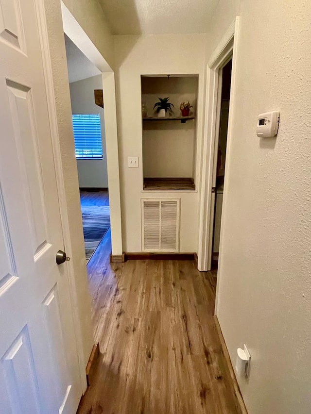 4955 Ledford Rd, Cosby, TN 37722 - hallway featuring visible vents, a textured wall, a textured ceiling, wood finished floors, and baseboards