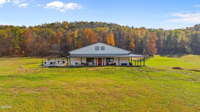 farmhouse inspired home featuring an outbuilding and a front yard