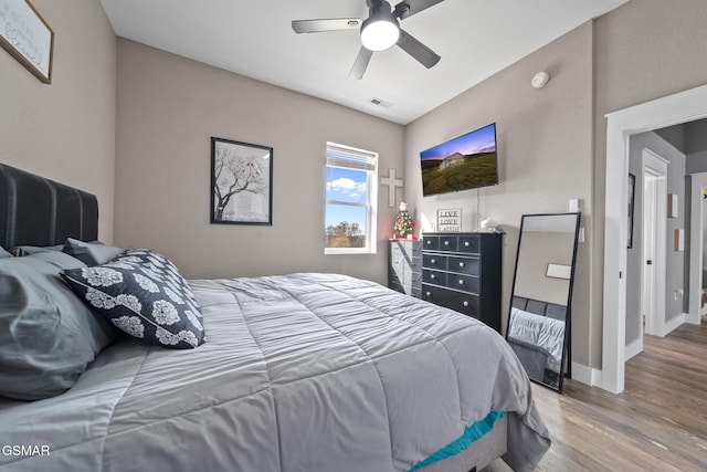 bedroom featuring hardwood / wood-style floors and ceiling fan