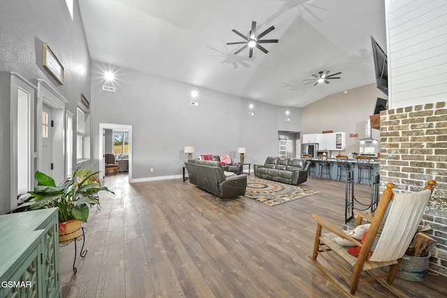 living room with a high ceiling and wood-type flooring