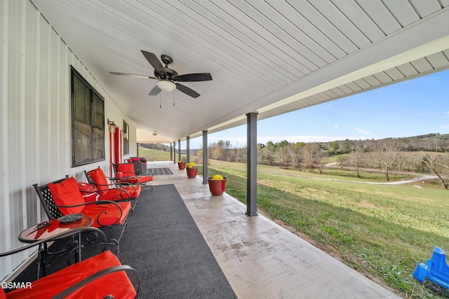 view of patio / terrace featuring ceiling fan and a rural view