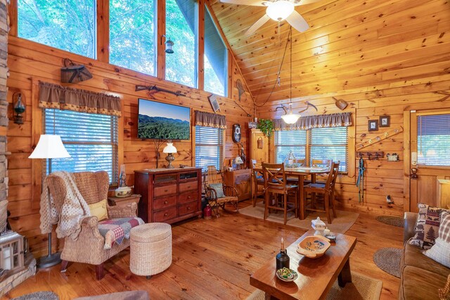 living room featuring plenty of natural light, ceiling fan, and light hardwood / wood-style floors