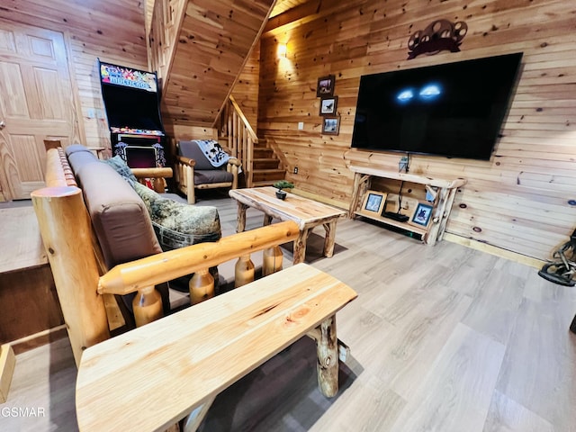 2527 Raccoon Hollow Way, Sevierville, TN 37862 - living area featuring wood walls, lofted ceiling, stairway, wood finished floors, and wooden ceiling
