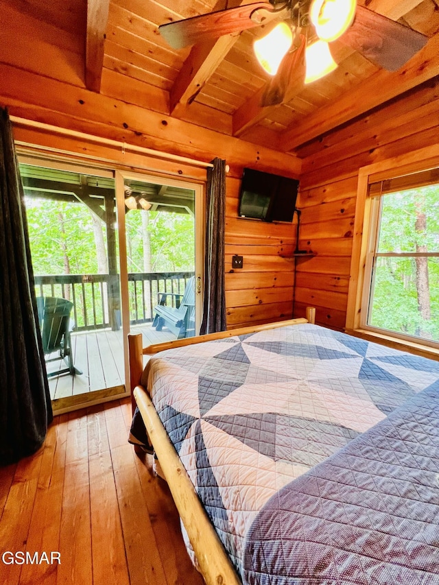 2527 Raccoon Hollow Way, Sevierville, TN 37862 - bedroom with access to exterior, a wood ceiling with exposed beams, multiple windows, hardwood / wood-style flooring, and wood walls
