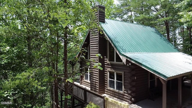 2527 Raccoon Hollow Way, Sevierville, TN 37862 - view of home's exterior featuring log siding, a chimney, a metal roof, and stairs