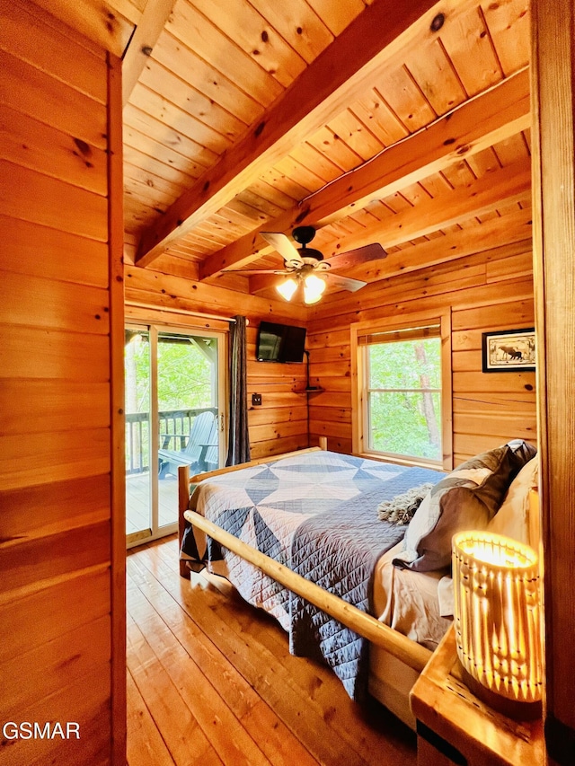 2527 Raccoon Hollow Way, Sevierville, TN 37862 - bedroom with access to exterior, wood walls, multiple windows, wood-type flooring, and a wooden ceiling with exposed beams