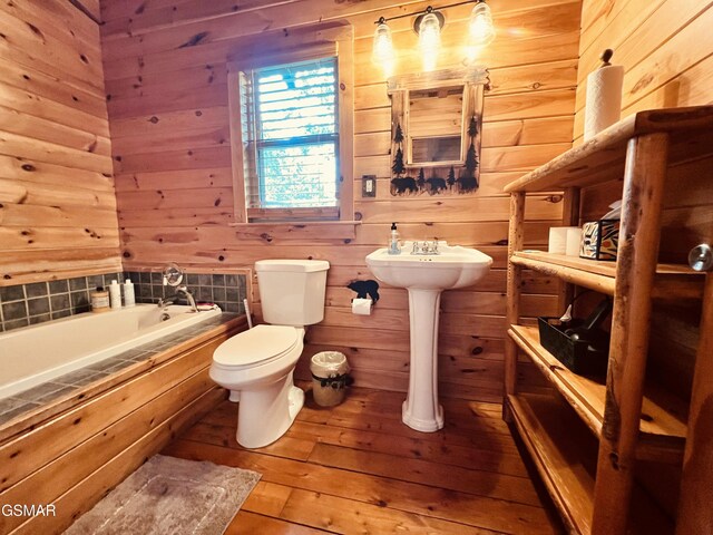 2527 Raccoon Hollow Way, Sevierville, TN 37862 - full bath featuring a relaxing tiled tub, wood walls, and hardwood / wood-style floors