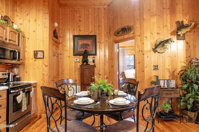 2210 Hawks Point Way, Sevierville, TN 37862 - dining space with wooden walls and light wood-type flooring