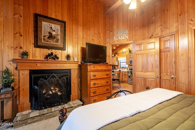 2210 Hawks Point Way, Sevierville, TN 37862 - bedroom with a high ceiling, wood walls, and a warm lit fireplace