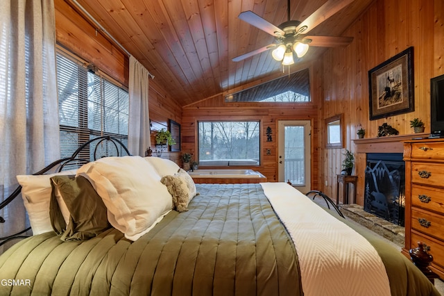 2210 Hawks Point Way, Sevierville, TN 37862 - bedroom with wood ceiling, wooden walls, access to exterior, a glass covered fireplace, and lofted ceiling