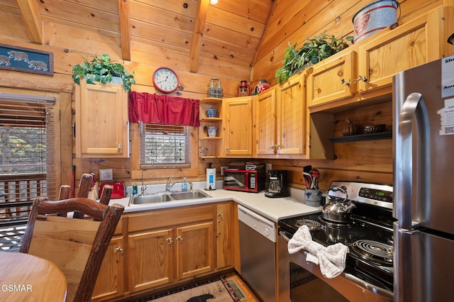 kitchen featuring stainless steel appliances, vaulted ceiling, sink, and wood walls