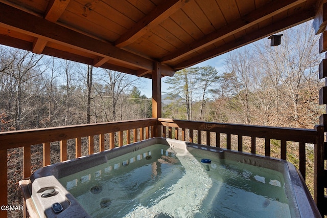 wooden deck featuring a hot tub