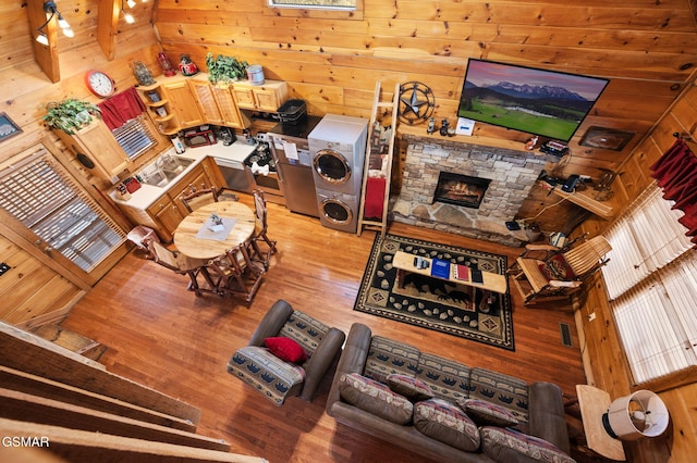 living room featuring light hardwood / wood-style flooring, a fireplace, and wooden walls