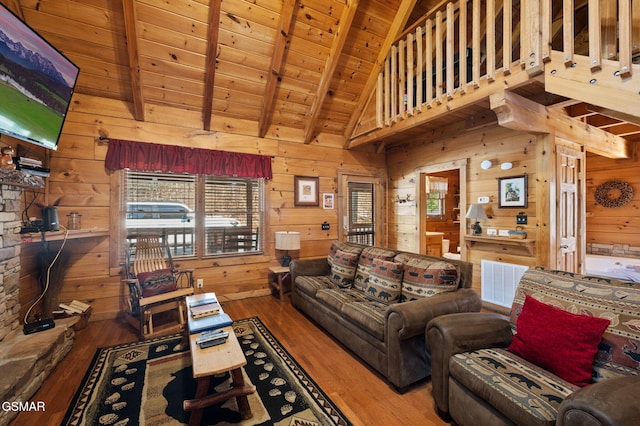 living room featuring wood ceiling, wooden walls, hardwood / wood-style flooring, and beamed ceiling