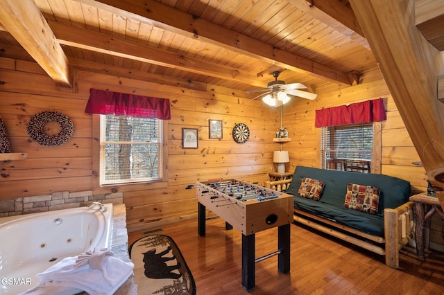 rec room with plenty of natural light, wooden ceiling, beamed ceiling, and wood-type flooring