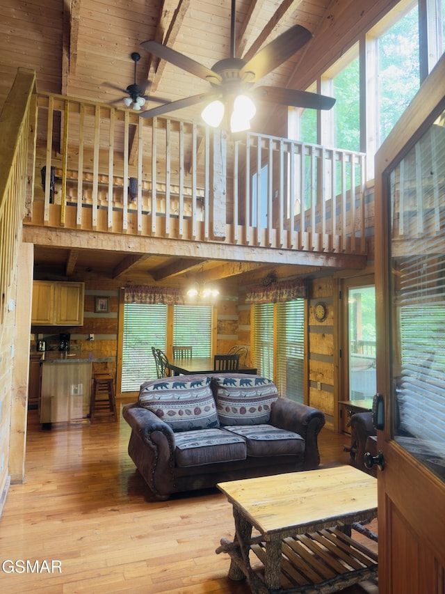 2575 Black Bear Ln, Sevierville, TN 37876 - living area featuring wood walls, beam ceiling, light wood-type flooring, ceiling fan, and wood ceiling