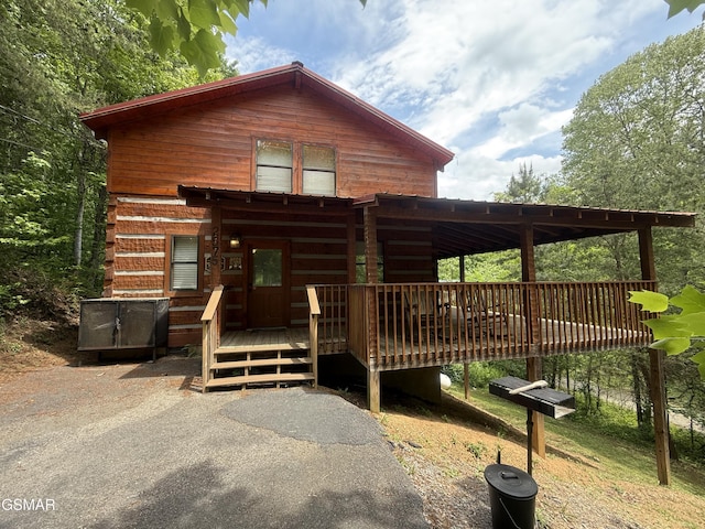 2575 Black Bear Ln, Sevierville, TN 37876 - log-style house featuring a wooden deck and a carport