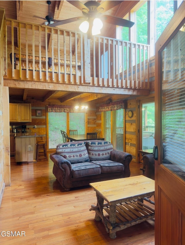 2575 Black Bear Ln, Sevierville, TN 37876 - living area with ceiling fan, wooden walls, a healthy amount of sunlight, and light wood-style floors